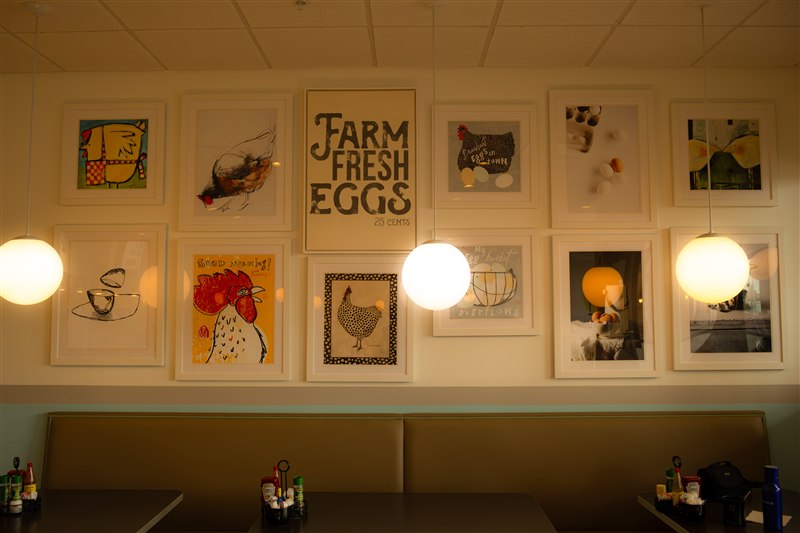 Warm restaurant interior with framed artwork